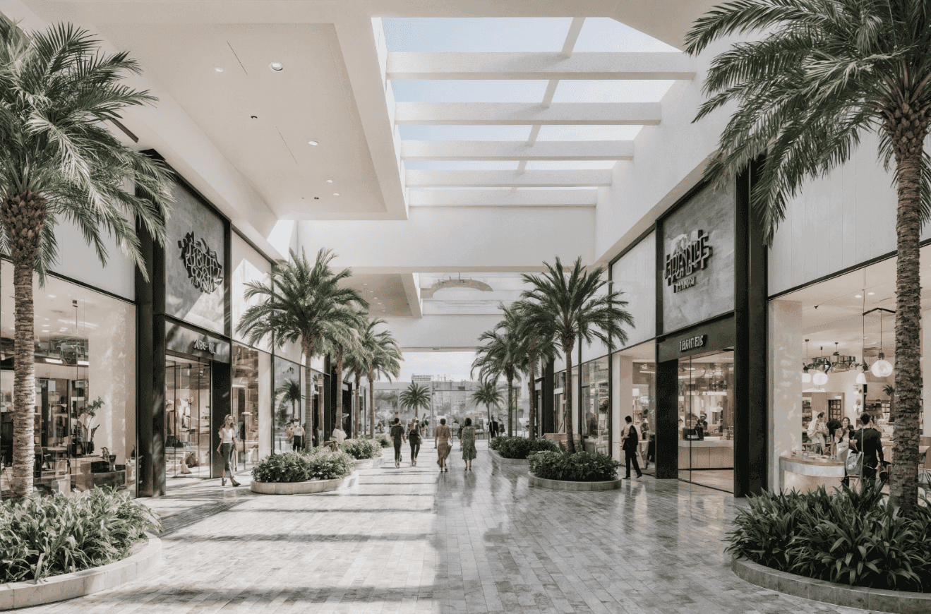 Indoor Commercial Walkway with Shops and Palm Trees